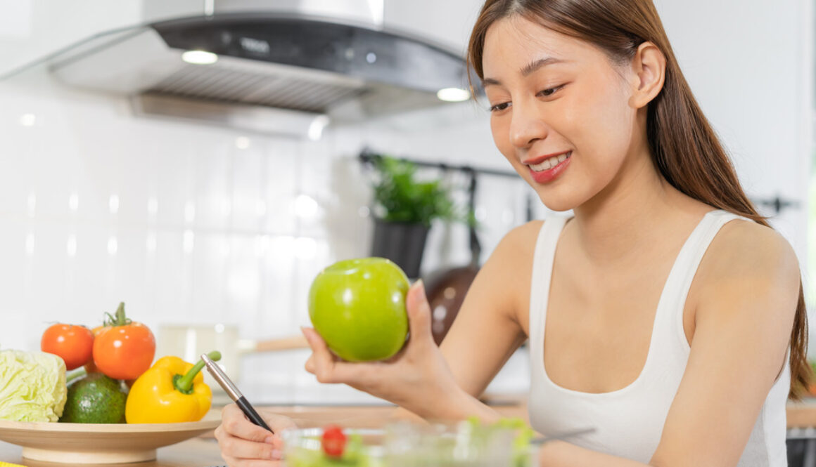 Young Asian Woman Eating a Salad to Follow Women’s Health Preventative Health Care Tips