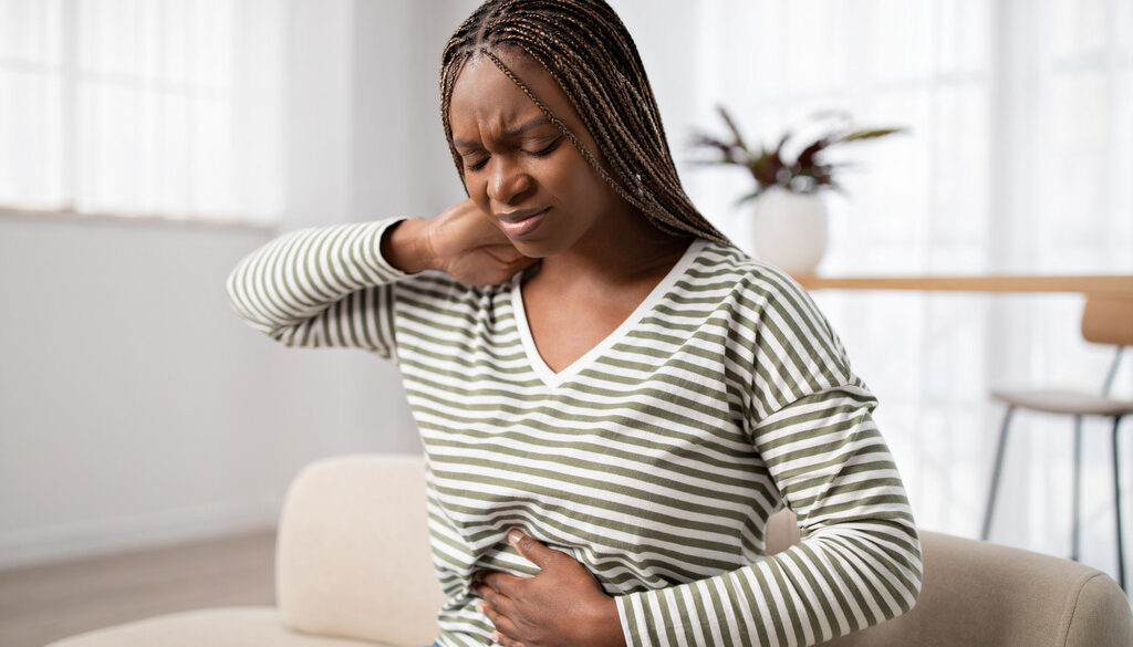 African-American Woman Wonders What Are Fibroids as She Has Difficult Menstrual Cramps