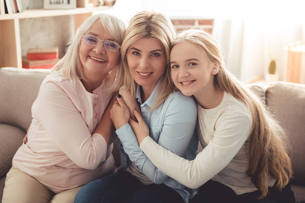 Three Generations of Women in a Family Sitting on a Couch Hugging Each Other Is Endometriosis Genetic